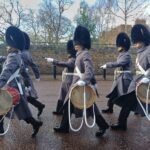 Guards in bearskin hats marching at the Changing of the Guard