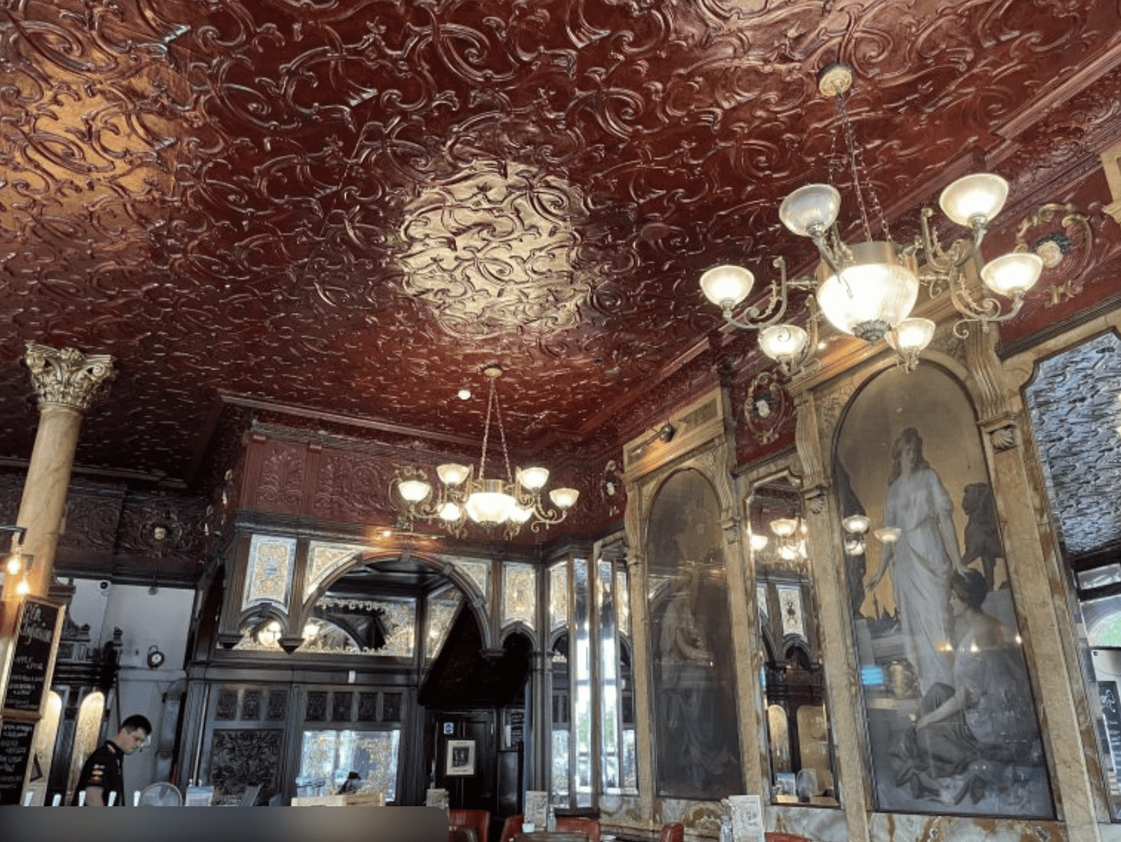 Ornate pressed-tin ceiling in a historic London pub